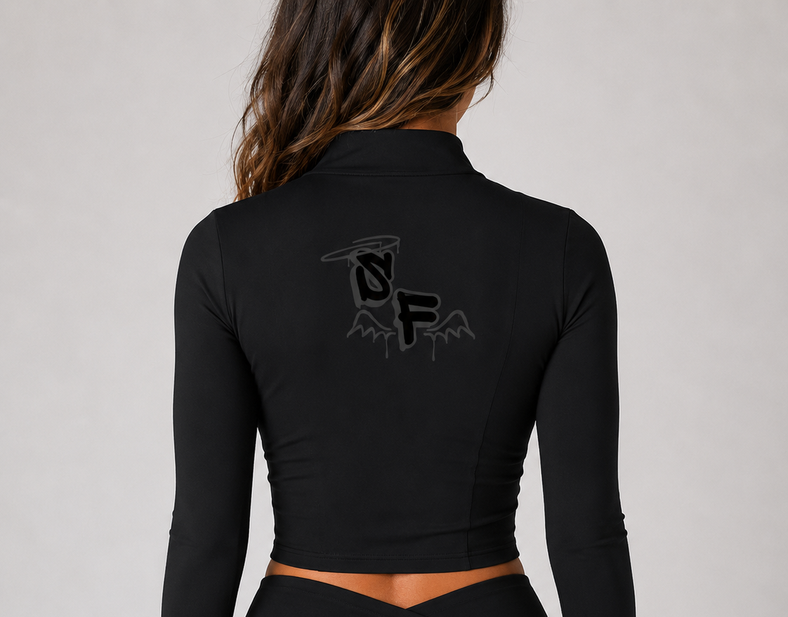 Black long-sleeve top and shorts with a logo on the back against a gray background