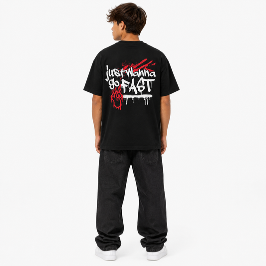 Person wearing a black t-shirt with white text on the back, standing against a white background