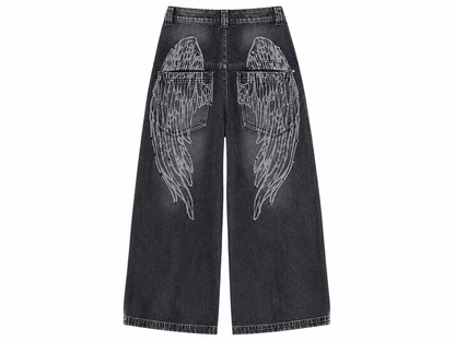 Black jeans with angel wing designs on a white background