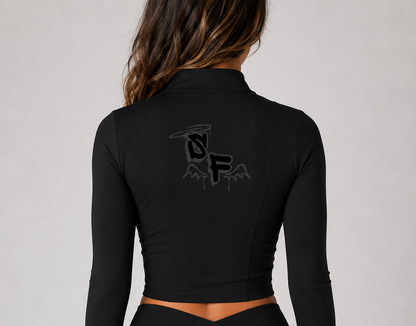 Black long-sleeve top and shorts with a logo on the back against a gray background