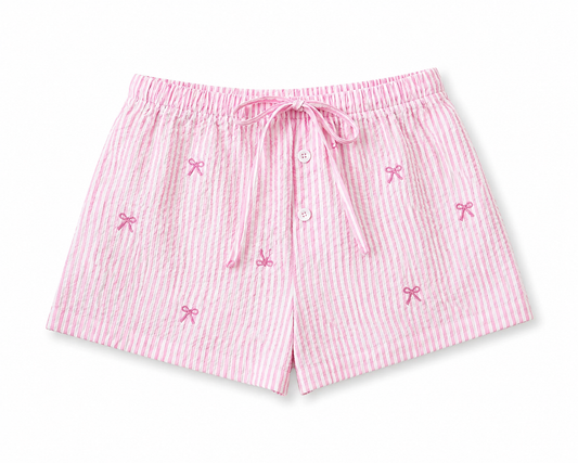 Pink striped shorts with bow details on a white background