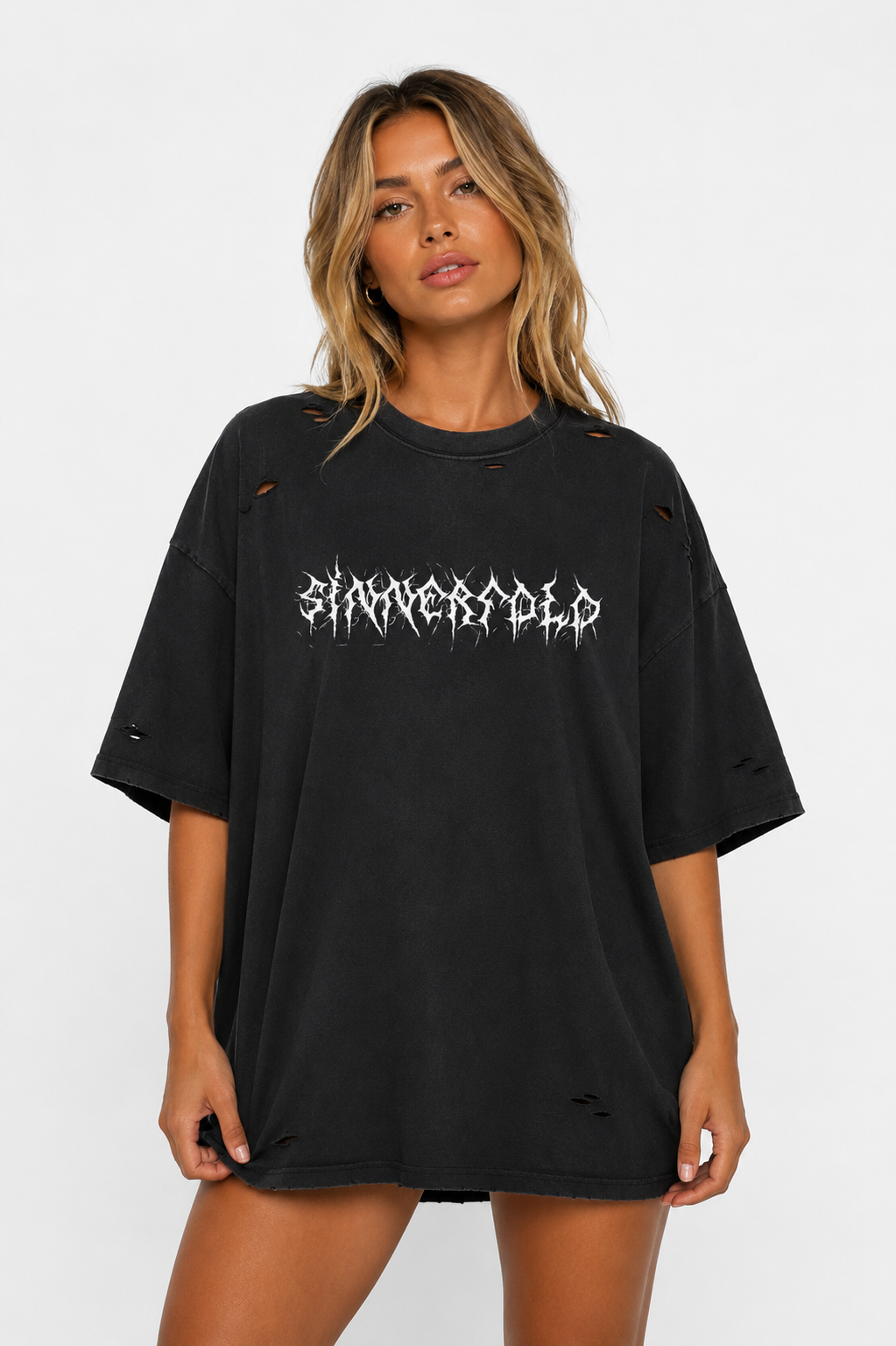 Woman wearing a black oversized t-shirt with white text on a white background