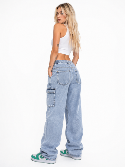 Woman wearing light blue cargo jeans on a white background