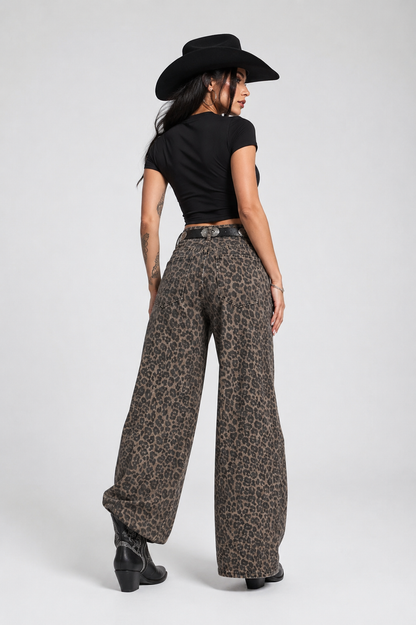 Person wearing leopard print pants and a black cowboy hat on a white background