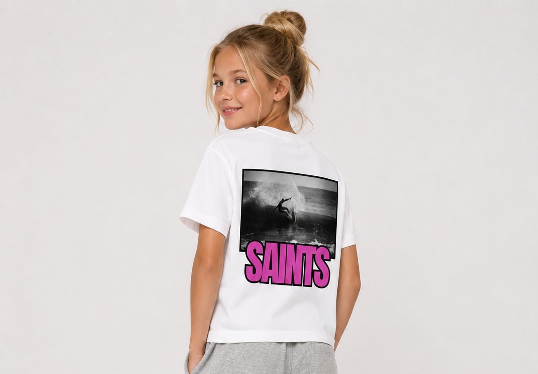 Child wearing a white t-shirt with 'SAINTS' print and gray sweatpants on a plain background