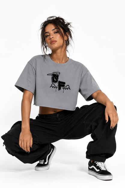 Person wearing a gray t-shirt with a graphic design and black pants on a white background
