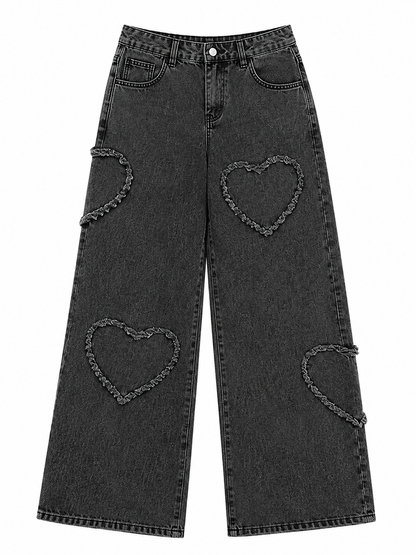Black denim jeans with heart-shaped cutouts on a white background