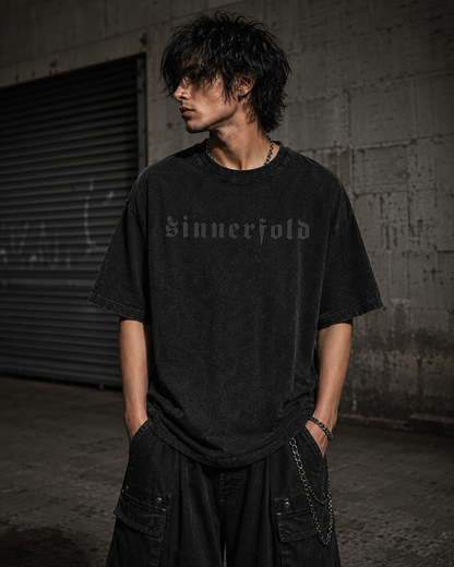 Person wearing a black t-shirt with 'Sinnerfold' text in an urban setting
